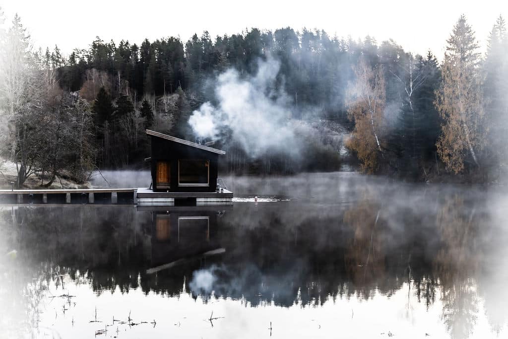 Flytende badstue i morgendis med røyk fra pipa