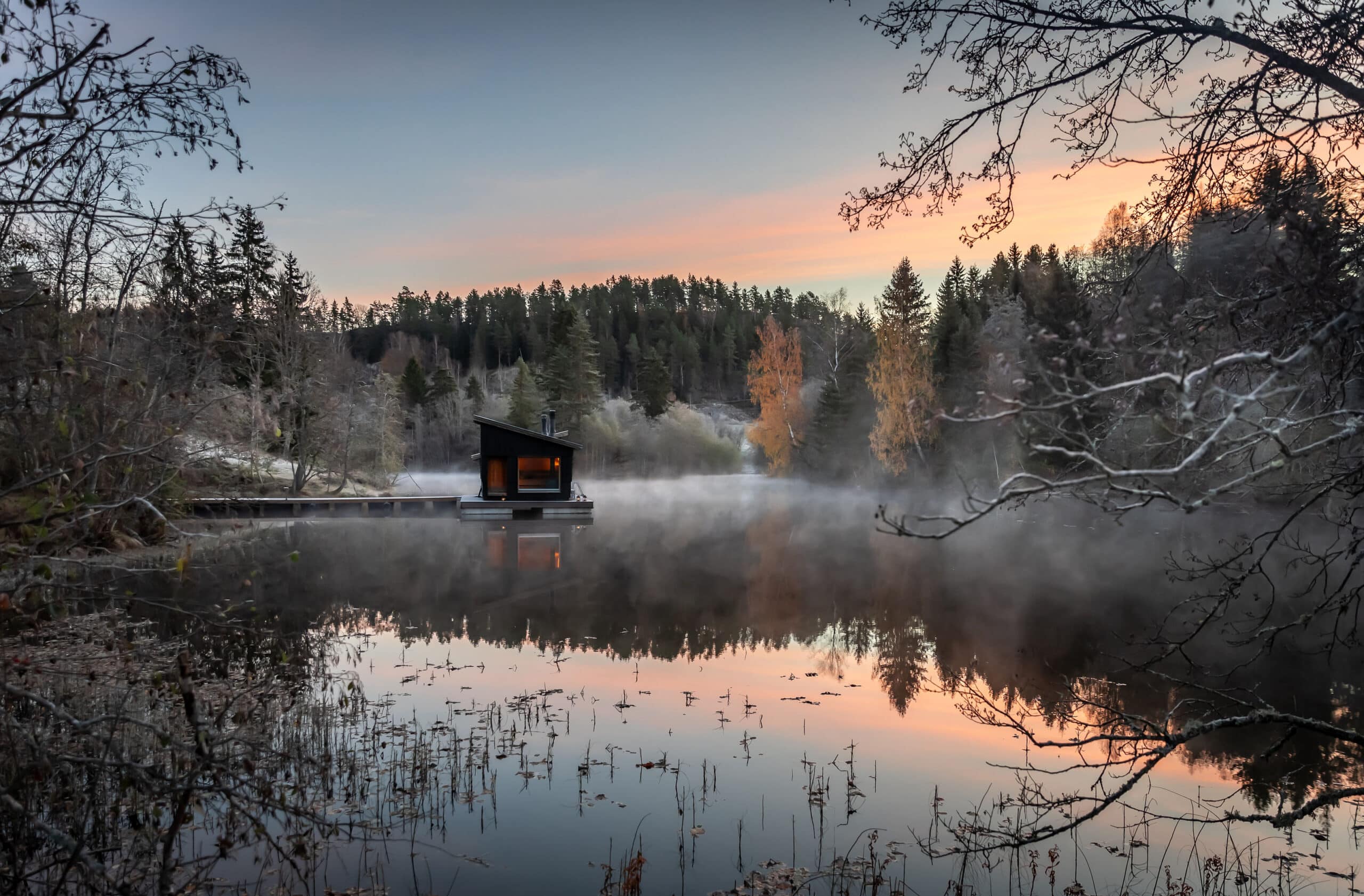 a small floating sauna on a misty lake